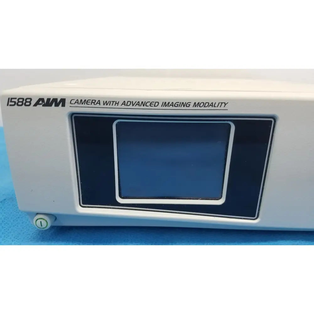 White rectangular stryker 1588 aim hd camera with advanced imaging modality and dark blue screen for reuse medical use