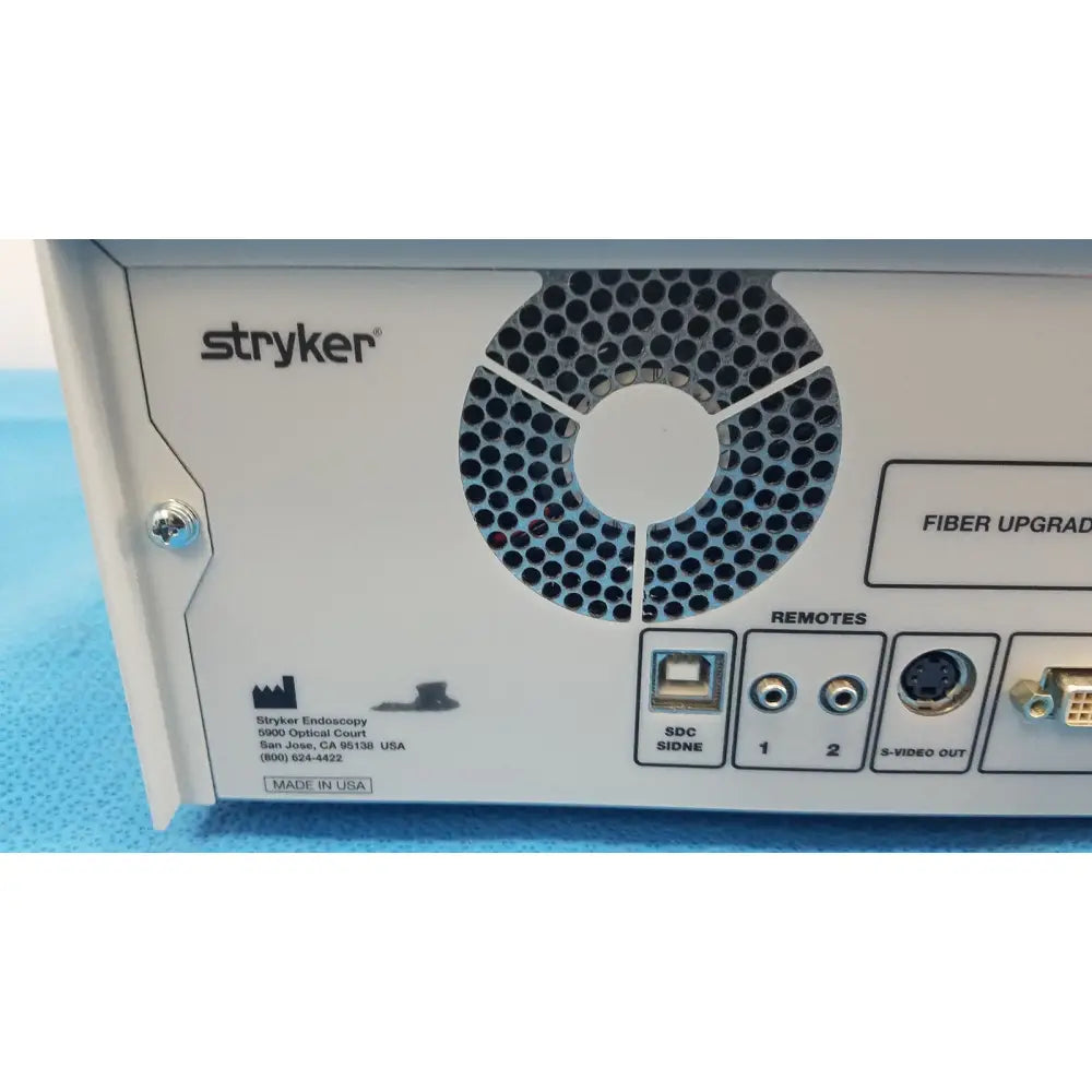 Back view of white stryker 1588 aim hd camera system with circular vent usb ports and audio video connectors for reuse medical use
