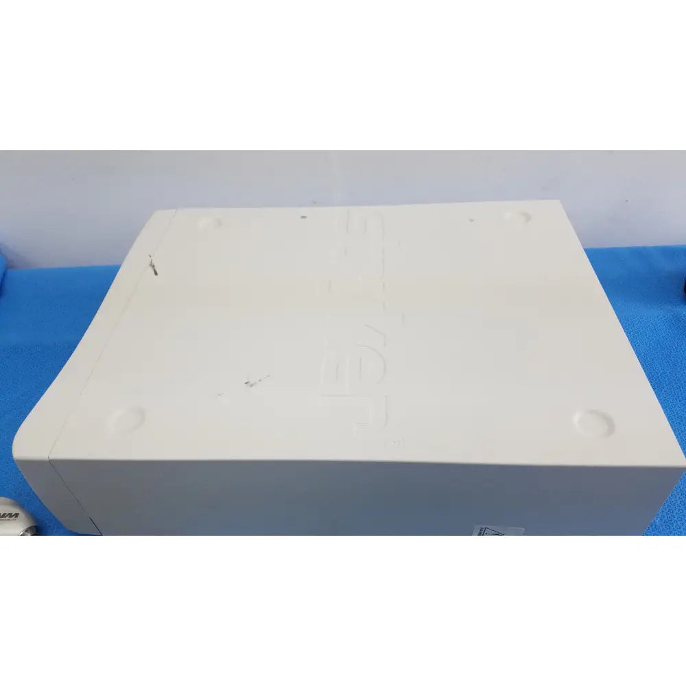 White plastic stryker 1588 aim hd camera system console with rounded edges and four circular indentations for reuse medical use