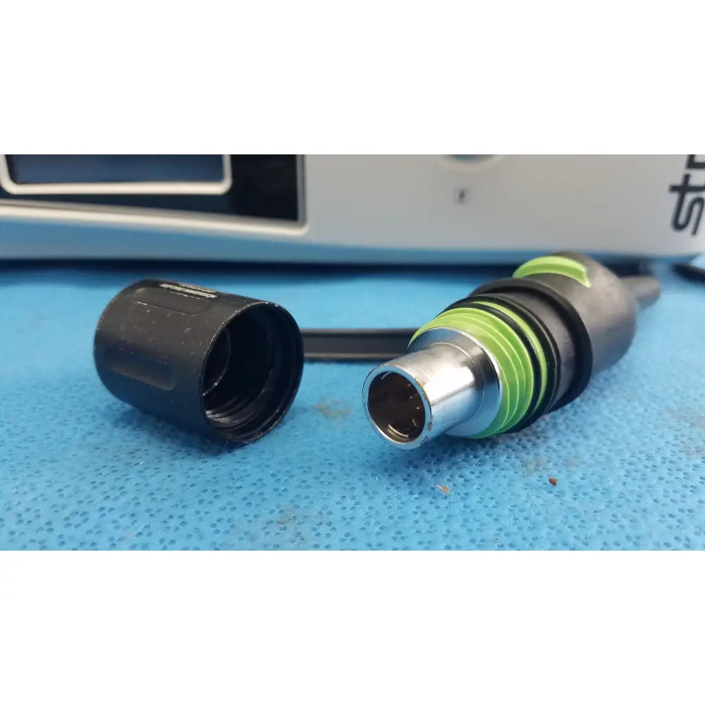 Black and green industrial connector with metallic plug end for stryker 1588 aim hd camera system reuse medical device