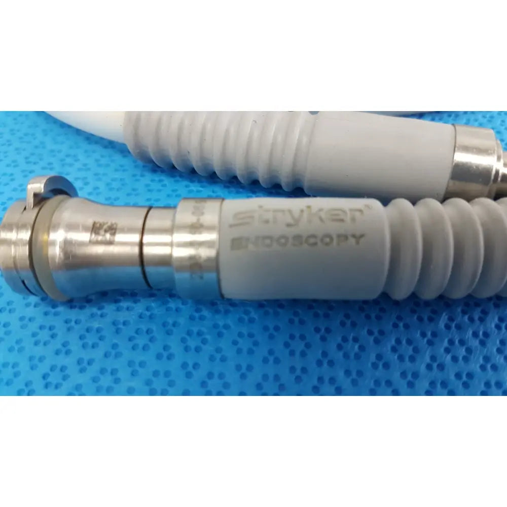 Stryker 195Q fiber optic light cable with metallic connector and gray ribbed tubing for surgical endoscopic illumination