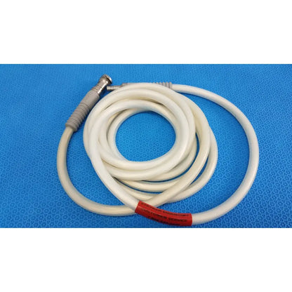 White coiled stryker 195q fiber optic light cable with metallic connector and gray grip for surgical illumination with customer service label