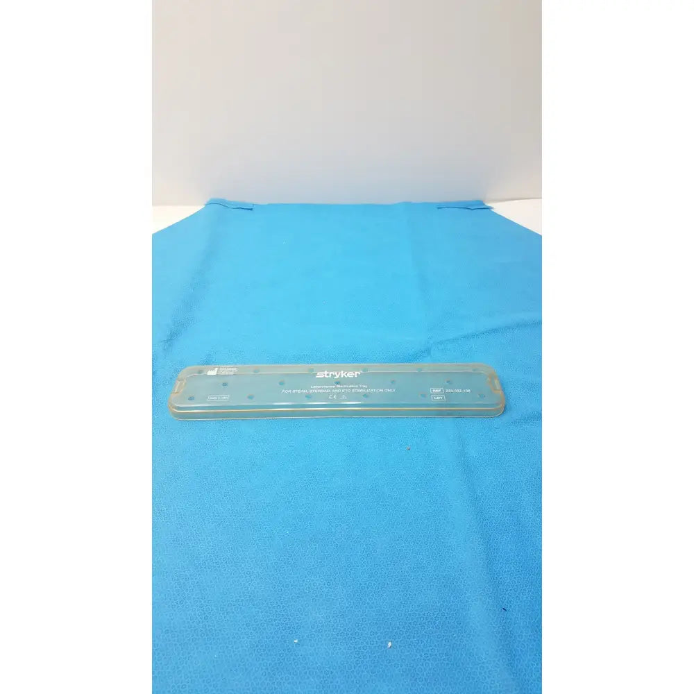 Transparent plastic stryker laparoscope sterilization tray lid with embossed branding and measurement markings