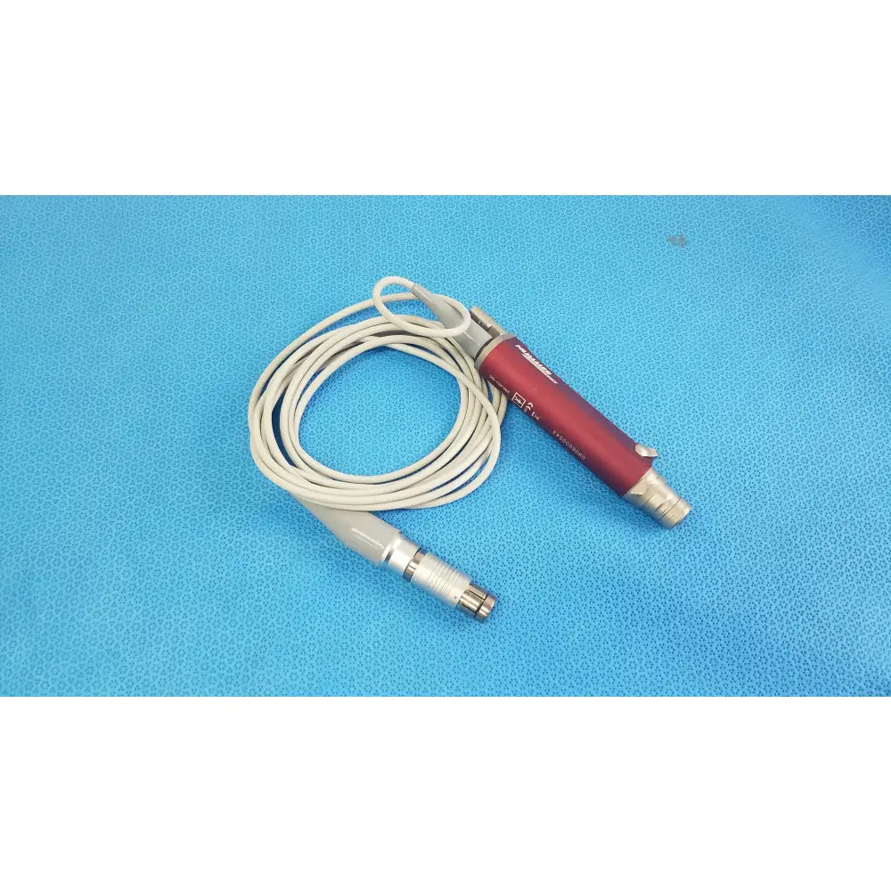 Red and silver tps leibinger hummer shaver handpiece with coiled white cable for precise surgical use