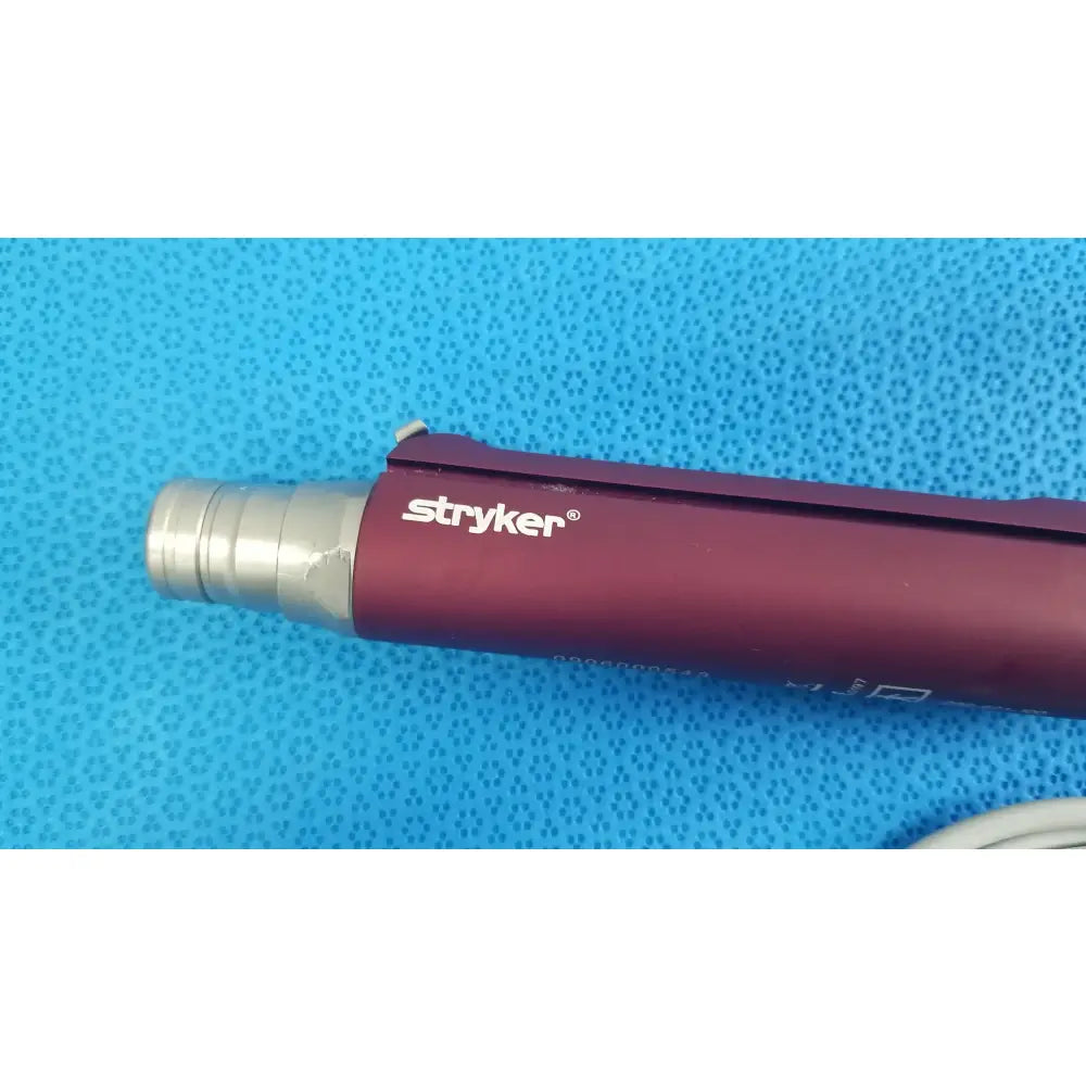 Maroon and silver tps leibinger hummer shaver handpiece with textured grip for precise surgical use