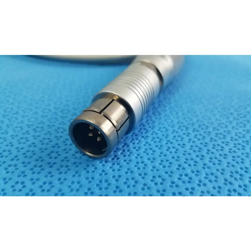 Silver metallic medical-grade connector with cylindrical ridged body and three pins for tps leibinger hummer shaver handpiece