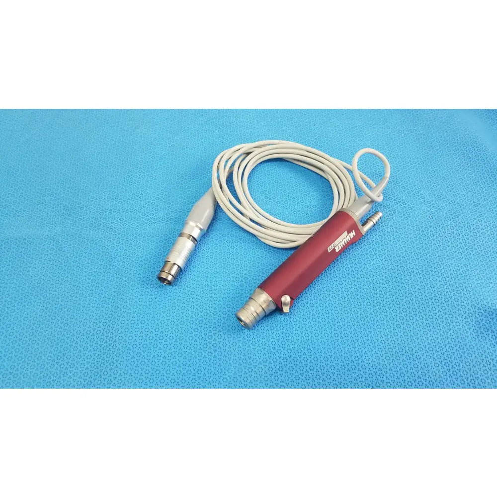 Red and silver Stryker TPS Leibinger Hummer shaver handpiece with coiled white cable for surgical use
