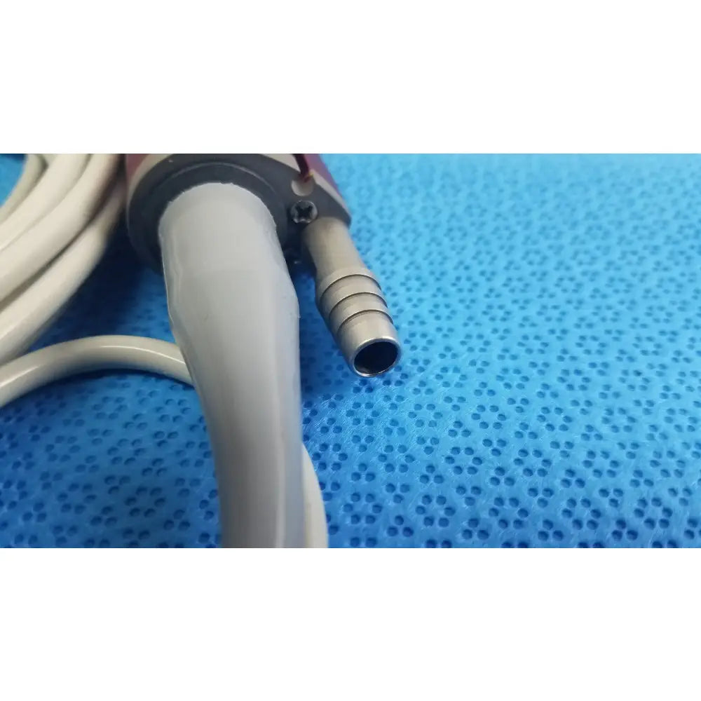 Gray shaver handpiece with metallic connector and white tubing for tps leibinger hummer surgical use