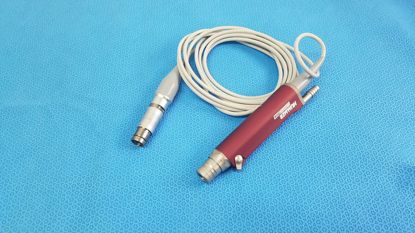 Red and silver Stryker TPS Leibinger Hummer shaver handpiece with coiled white cable for surgical use
