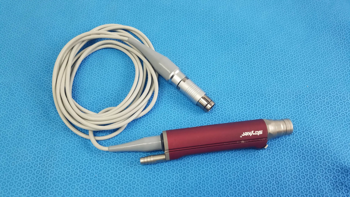 Red and gray Stryker 290-601-100 TPS Leibinger Hummer shaver handpiece with coiled white cable for surgical use