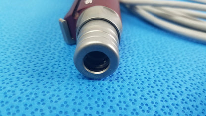 Maroon and silver tps leibinger hummer shaver handpiece with cylindrical lens housing for medical use by Stryker