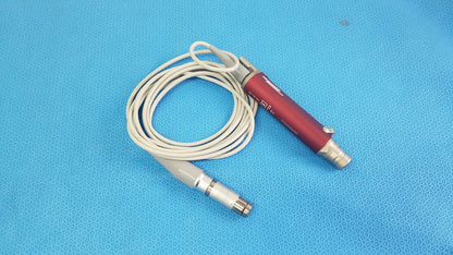 Red and silver tps leibinger hummer shaver handpiece with coiled white cable for precise surgical use