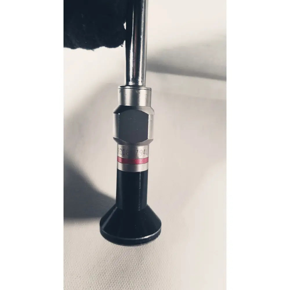 Black and silver Stryker 380-10mm 0 degree rigid laparoscope tip with hexagonal metallic collar and red stripe