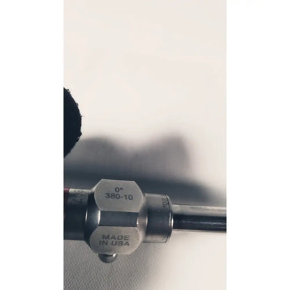 Silver metallic end cap with engraved markings 0° 380-10 made in usa attached to a stryker 380-10mm 0 degree rigid laparoscope