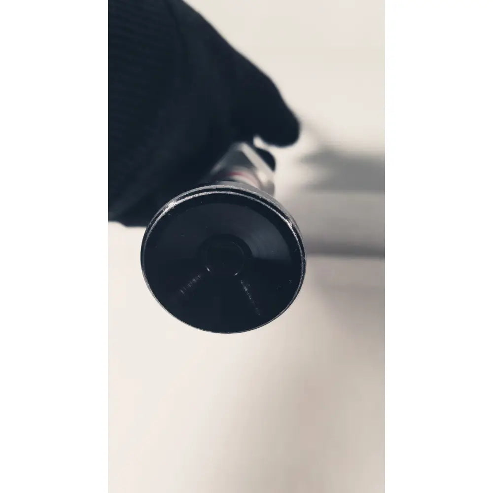 Black cylindrical flashlight with matte finish and textured grip used as a 380-10mm 0 degree rigid laparoscope tool