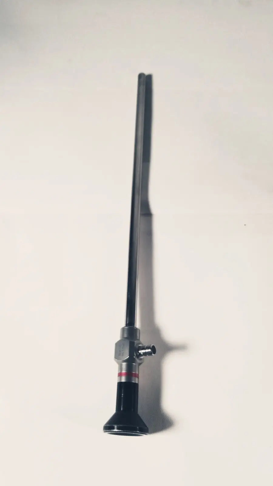 Black and silver Stryker 380-10mm 0 degree rigid laparoscope with slender shaft and cylindrical metallic handle