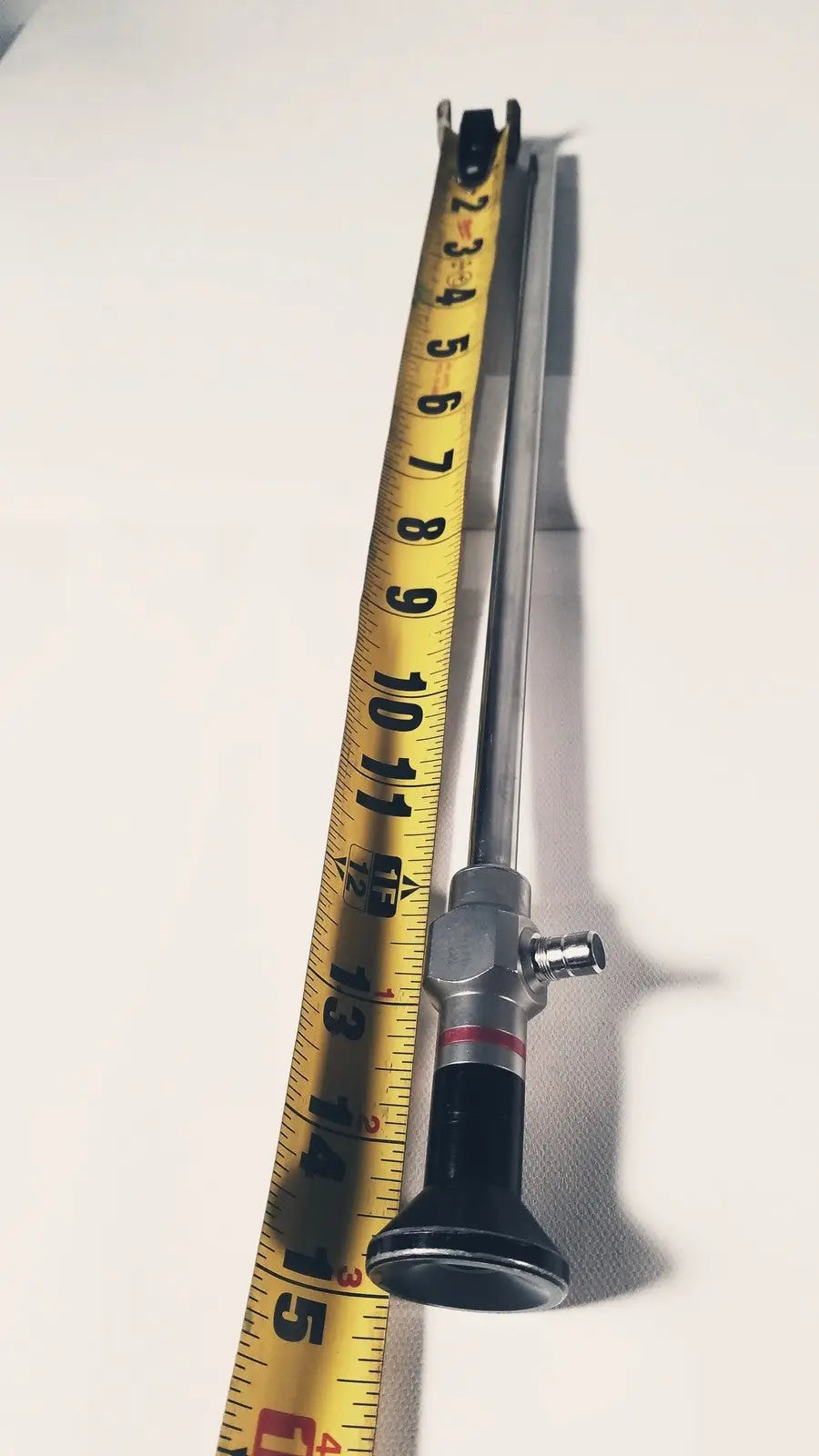 Stryker 380-10mm 0 degree rigid laparoscope with silver and black metallic shaft and red accent band on textured grip handle