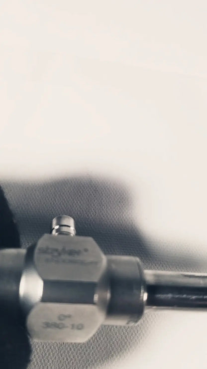 Silver metallic Stryker 380-10mm 0 degree rigid laparoscope with engraved markings and black cylindrical handle