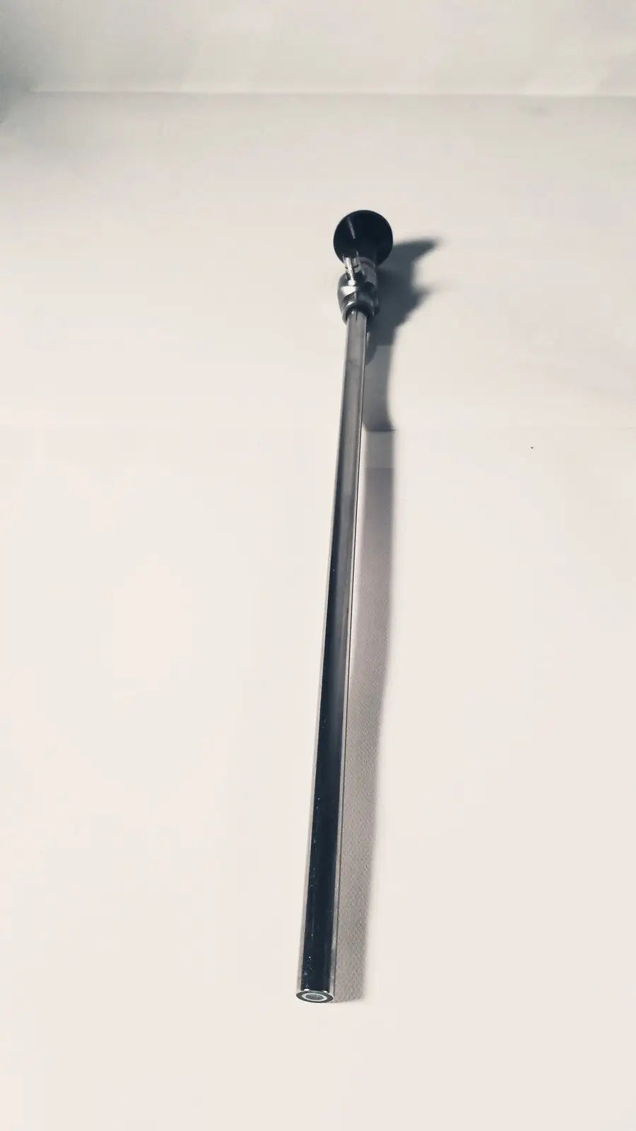A sleek chrome 380-10mm 0 degree rigid laparoscope with a black spherical cap for precise surgical visualization