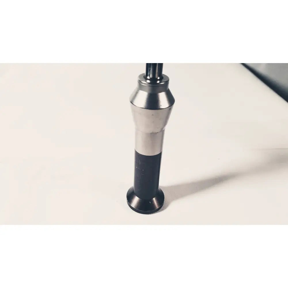 Silver and black impact hammer with cylindrical metallic head and textured grip handle for reuse medical applications