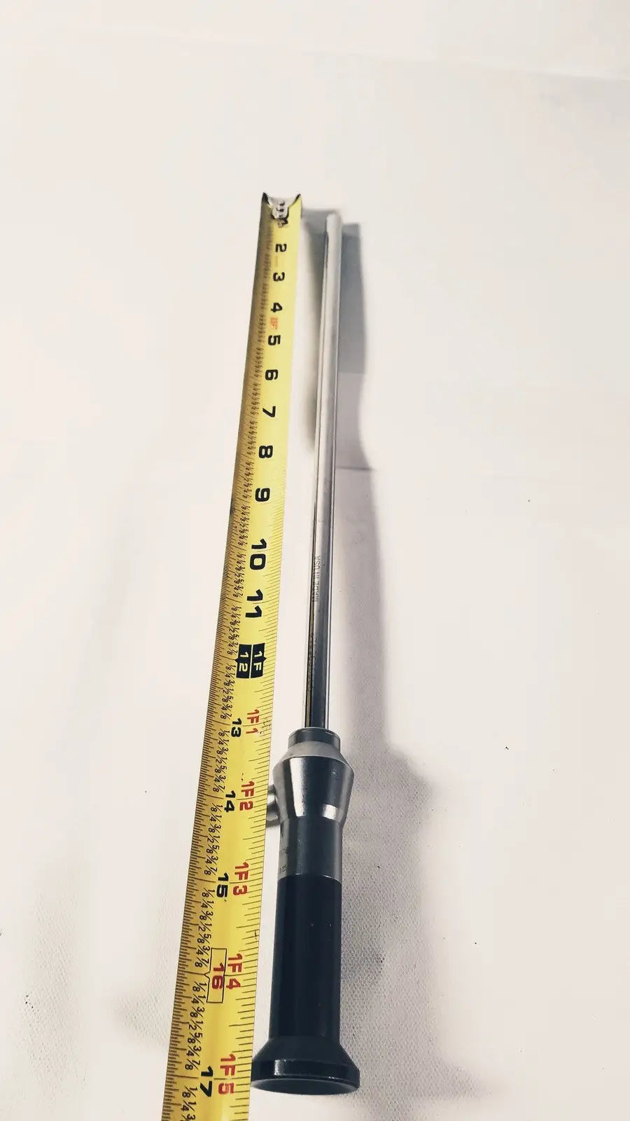 Silver stryker 380-11 laparoscope 0 degree 10 mm with black ergonomic handle and yellow tape for reuse medical procedures