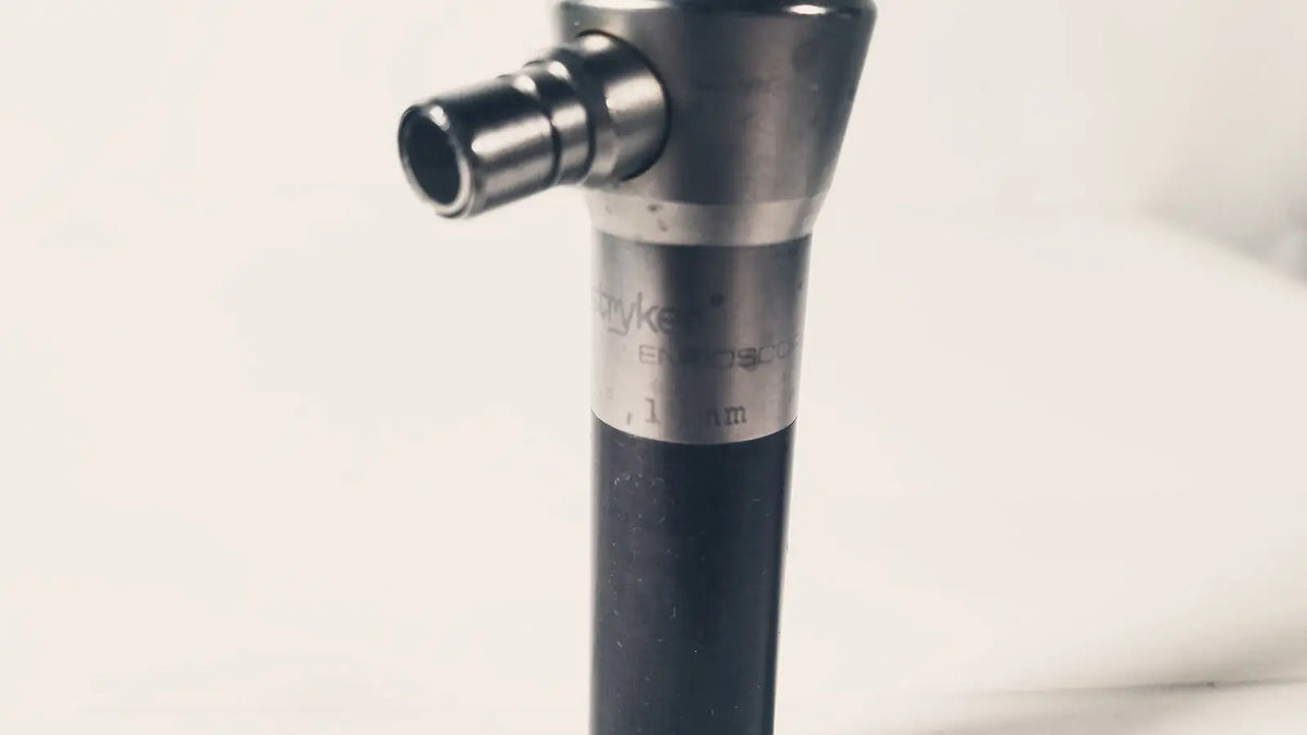 A sleek metallic stryker 380-11 laparoscope 0 degree 10 mm with black grip suitable for reuse medical procedures