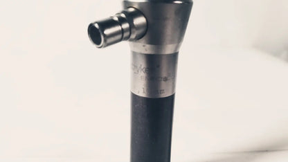 A sleek metallic stryker 380-11 laparoscope 0 degree 10 mm with black grip suitable for reuse medical procedures