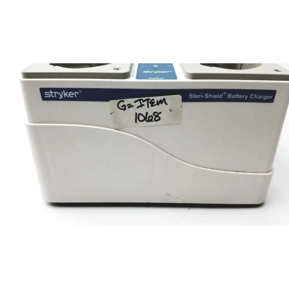 White stryker 400-655 steri-shield t4 eight station battery charger with blue branding and handwritten label