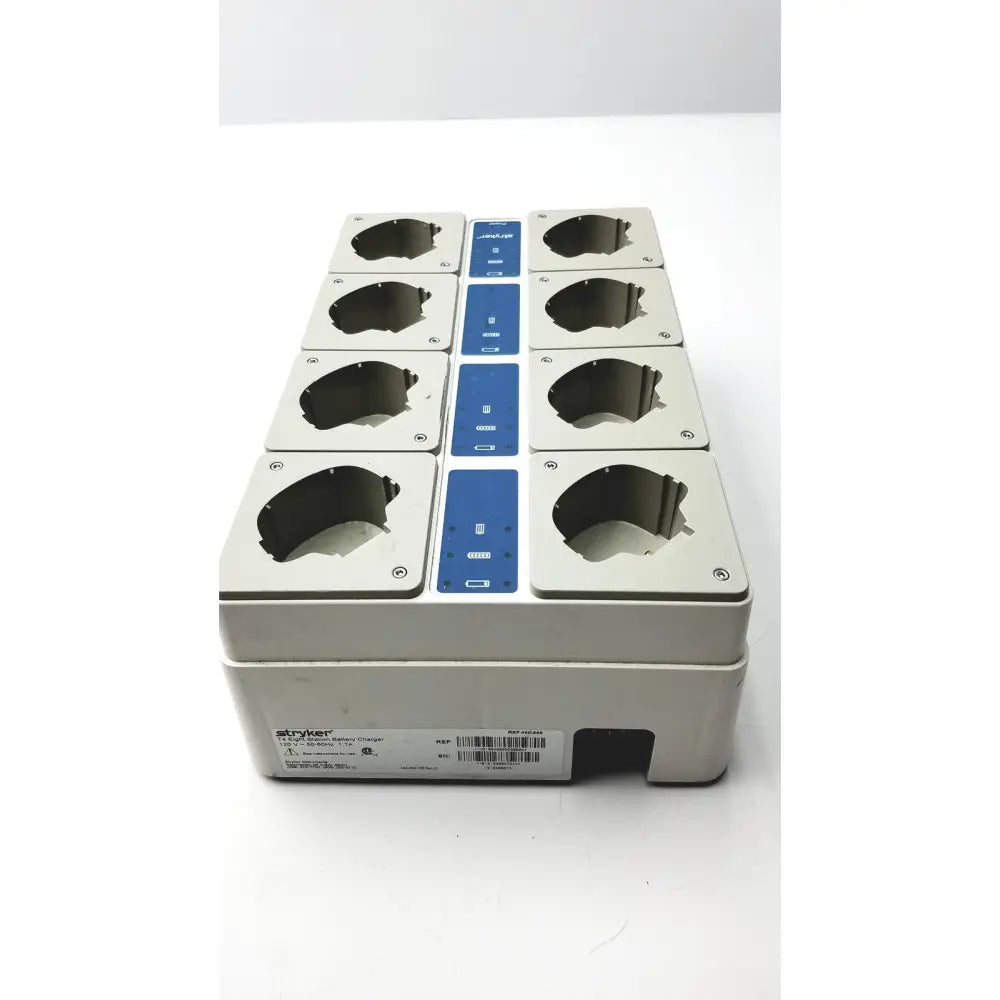 Gray plastic stryker 12-port surgical instrument tray with blue control panels for eight station battery charging