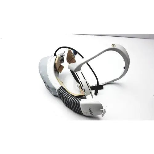 White and gray oculus quest 2 vr headset with visible internals and packaging next to stryker 047kg personal protection flyte helmet