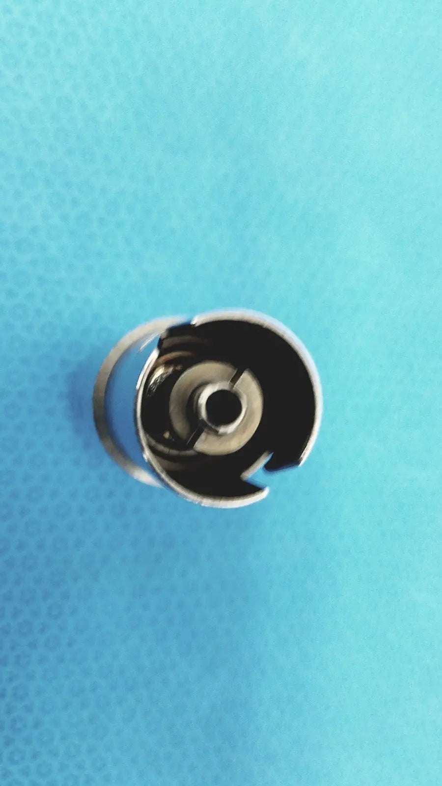 Silver metal sewing machine bobbin case with circular open design for stryker 4100-110 synthes style small drill attachment