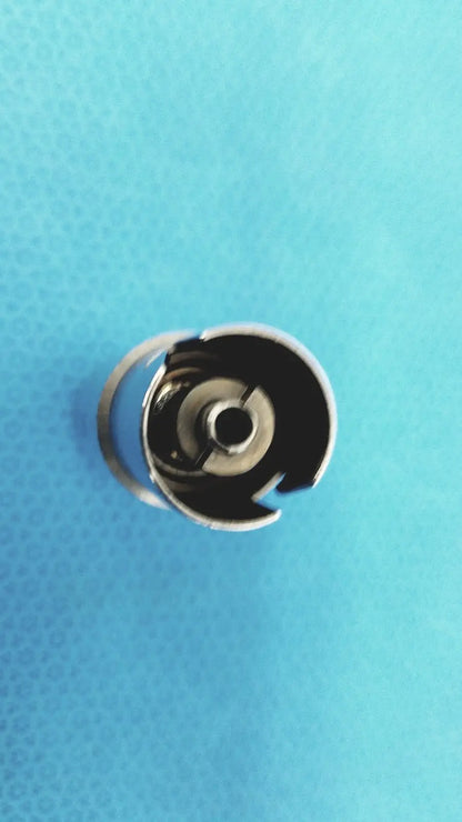 Silver metal sewing machine bobbin case with circular open design for stryker 4100-110 synthes style small drill attachment