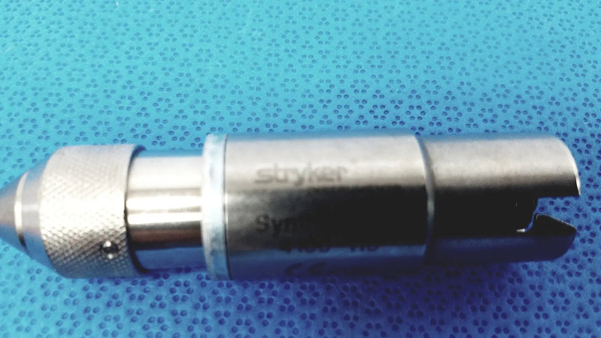 Silver metallic stryker synthes style small drill attachment with textured grip and curved end for precision use