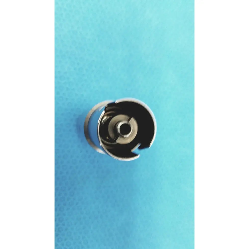 Silver metal sewing machine bobbin case with circular open design for stryker 4100-110 synthes style small drill attachment