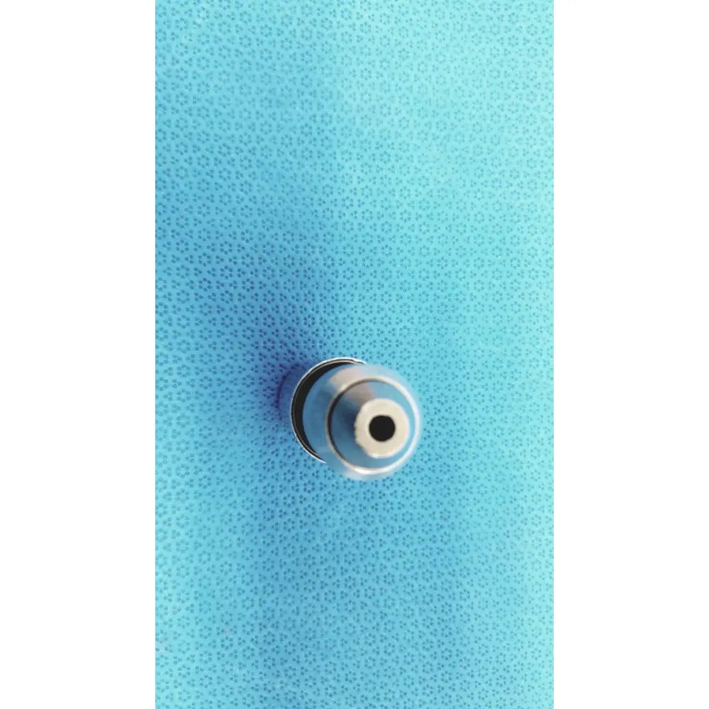 Silver metallic synthes style small drill attachment tip with circular hollow center and concentric rings for precise drilling