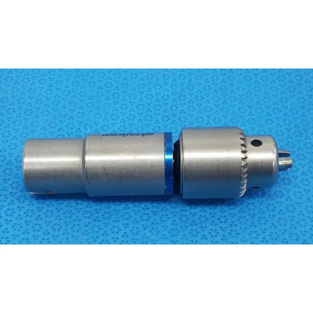 Stryker 4100-131-000 silver metal drill attachment with blue accent ring and engraved branding for reuse medical use