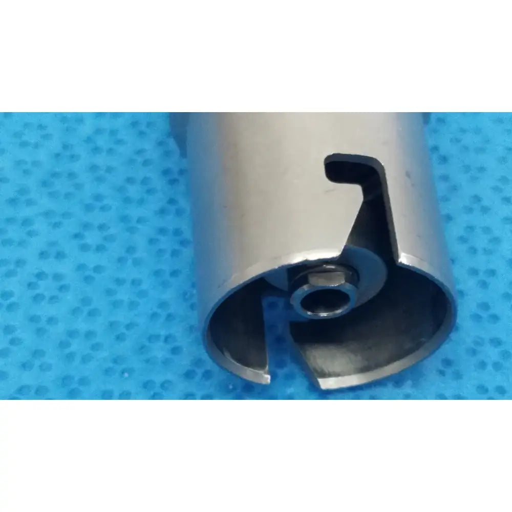 Silver metallic cylindrical keyless drill attachment with cutout handle and central threaded hole for reuse medical use