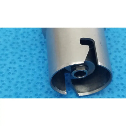 Silver metallic cylindrical keyless drill attachment with cutout handle and central threaded hole for reuse medical use