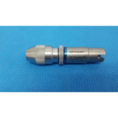 Stryker 4100-133-000 silver metallic 1/4 inch keyless drill attachment with textured grip and blue accent band for reuse medical use