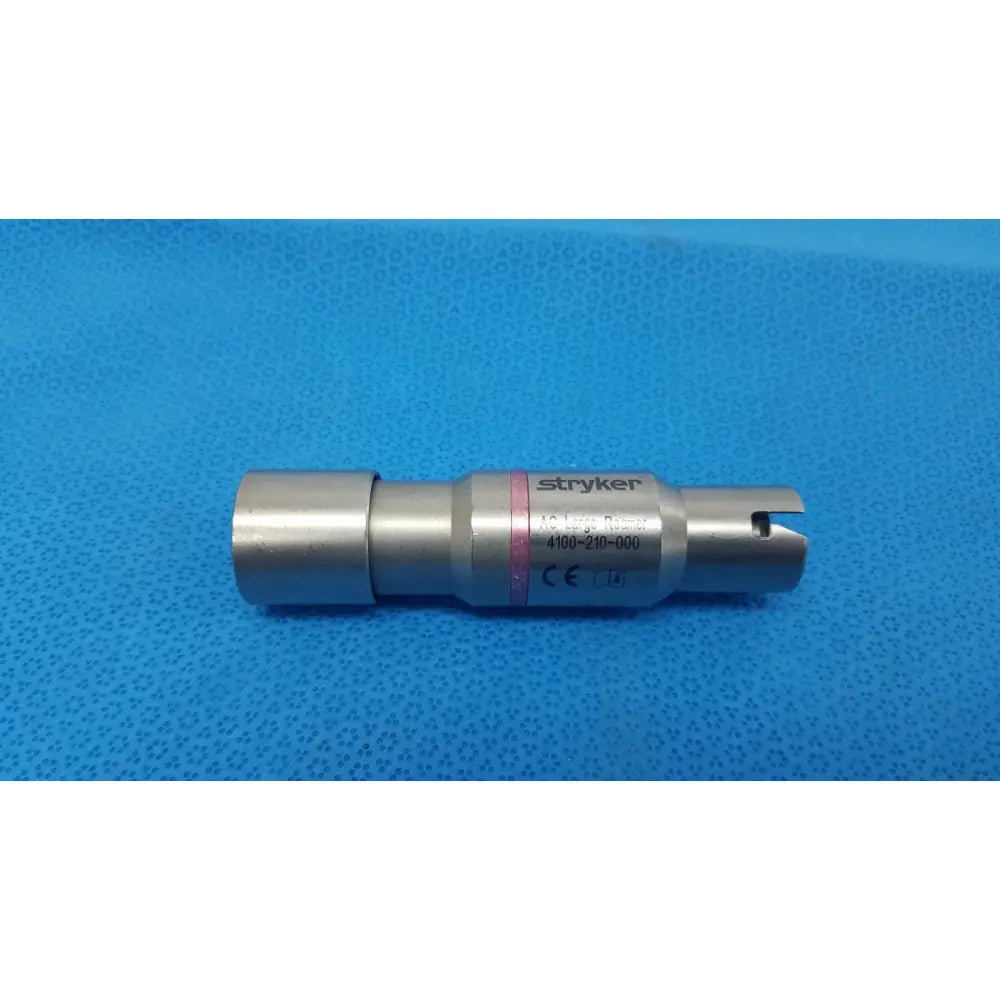 Silver metallic stryker 4100-210-000 large reamer attachment with cylindrical body, engraved markings, and pink stripe for reuse medical use