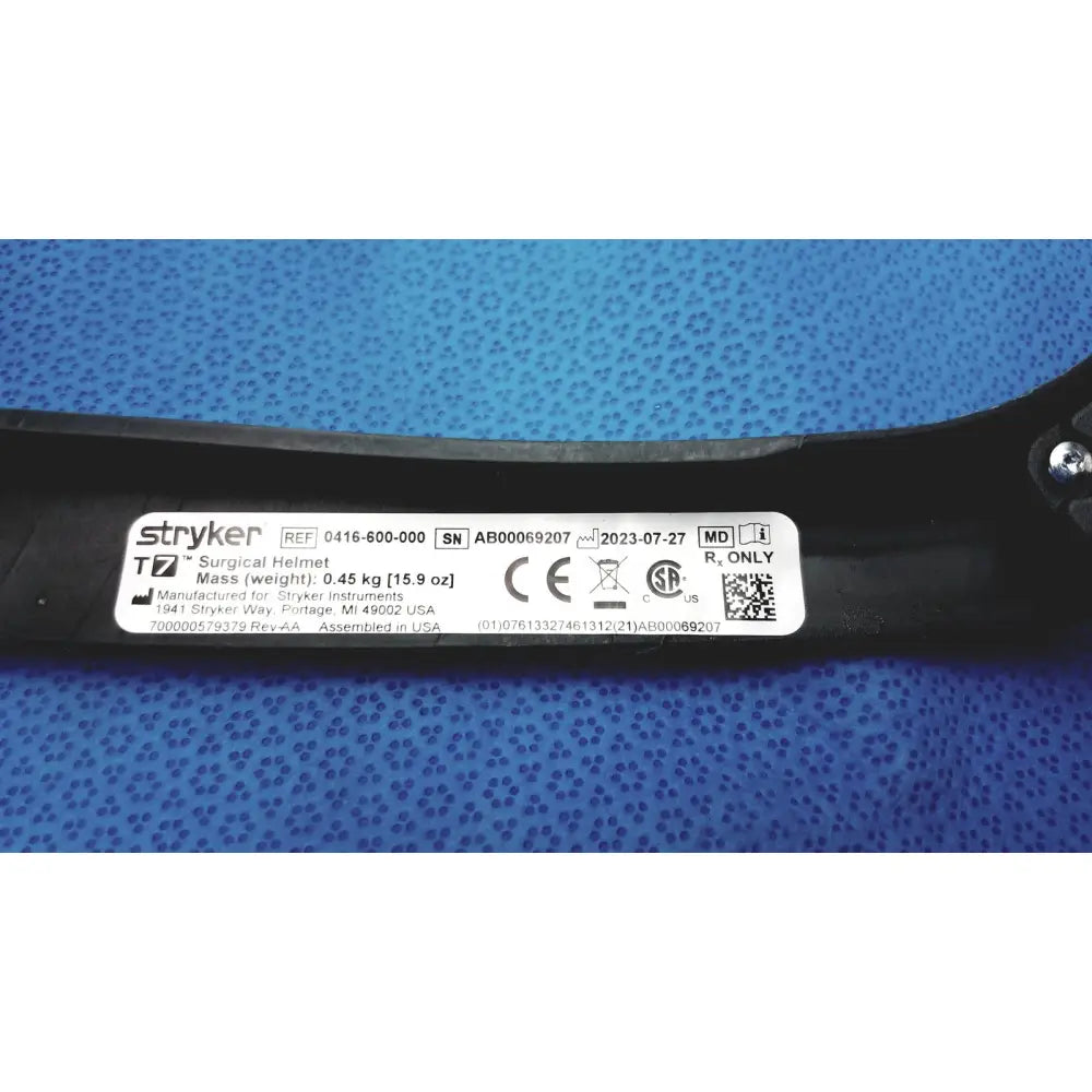 Black Stryker 416-600-000 surgical helmet with white label showing specifications and power cord protective headgear details