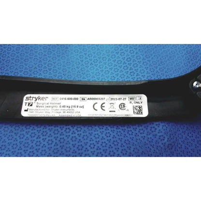 Black Stryker 416-600-000 surgical helmet with white label showing specifications and power cord protective headgear details
