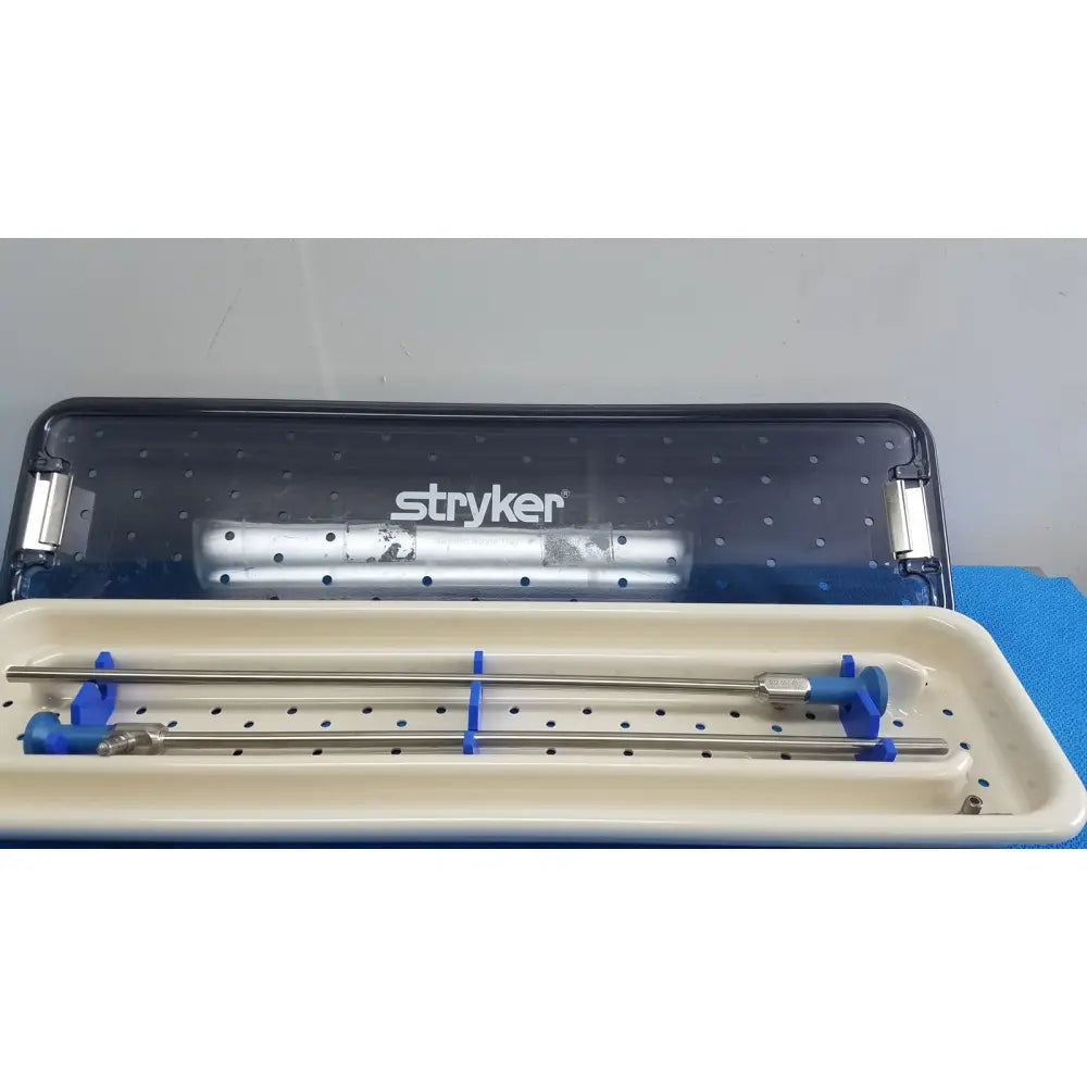 Stryker ideal eyes 10mm surgical instrument tray with two metallic rods and blue plastic clamps autoclavable