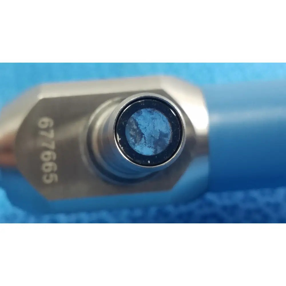 Silver-toned hexagonal tool head with blue-tinted lens marked 67965 of Stryker ideal eyes 10mm autoclavable endoscope
