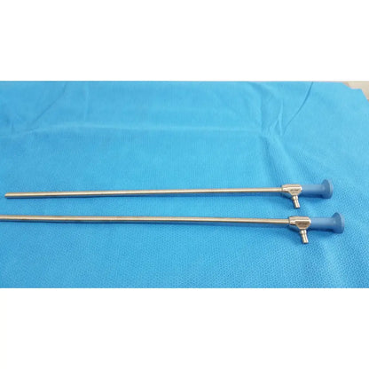Two metallic ideal eyes 10mm surgical scopes with blue rubber handles lying parallel on textured blue surface