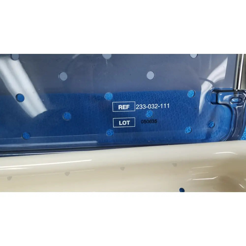 Blue plastic label with white text and circular blue dots on stryker ideal eyes 10mm autoclavable tray