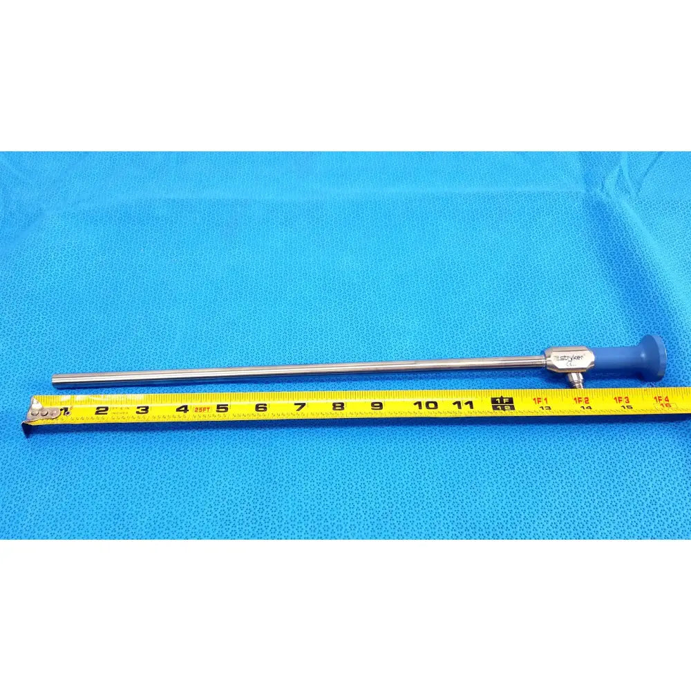Silver stryker 502-457-010 10mm 0° autoclavable endoscope with blue ergonomic handle and metallic joints on measuring tape