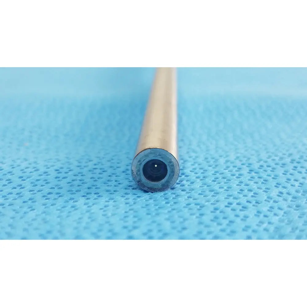 A metallic autoclavable cylindrical endoscope with a dark opening resting on blue surface ideal eyes 10mm