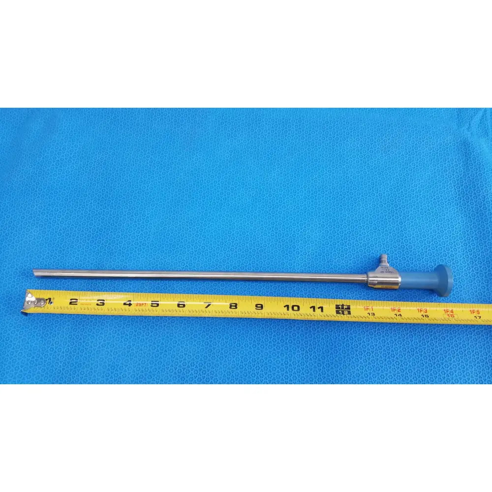 Silver surgical endoscope with blue ergonomic handle and metallic shaft beside yellow tape measure for ideal eyes 10mm use