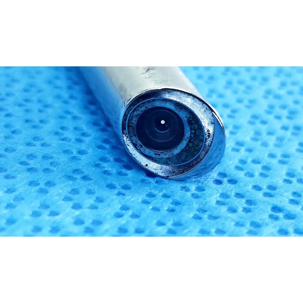 Silver cylindrical ideal eyes 10mm autoclavable endoscope with circular lens and visible dirt around edges by stryker